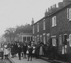 Children standing on the pavement outside cottages